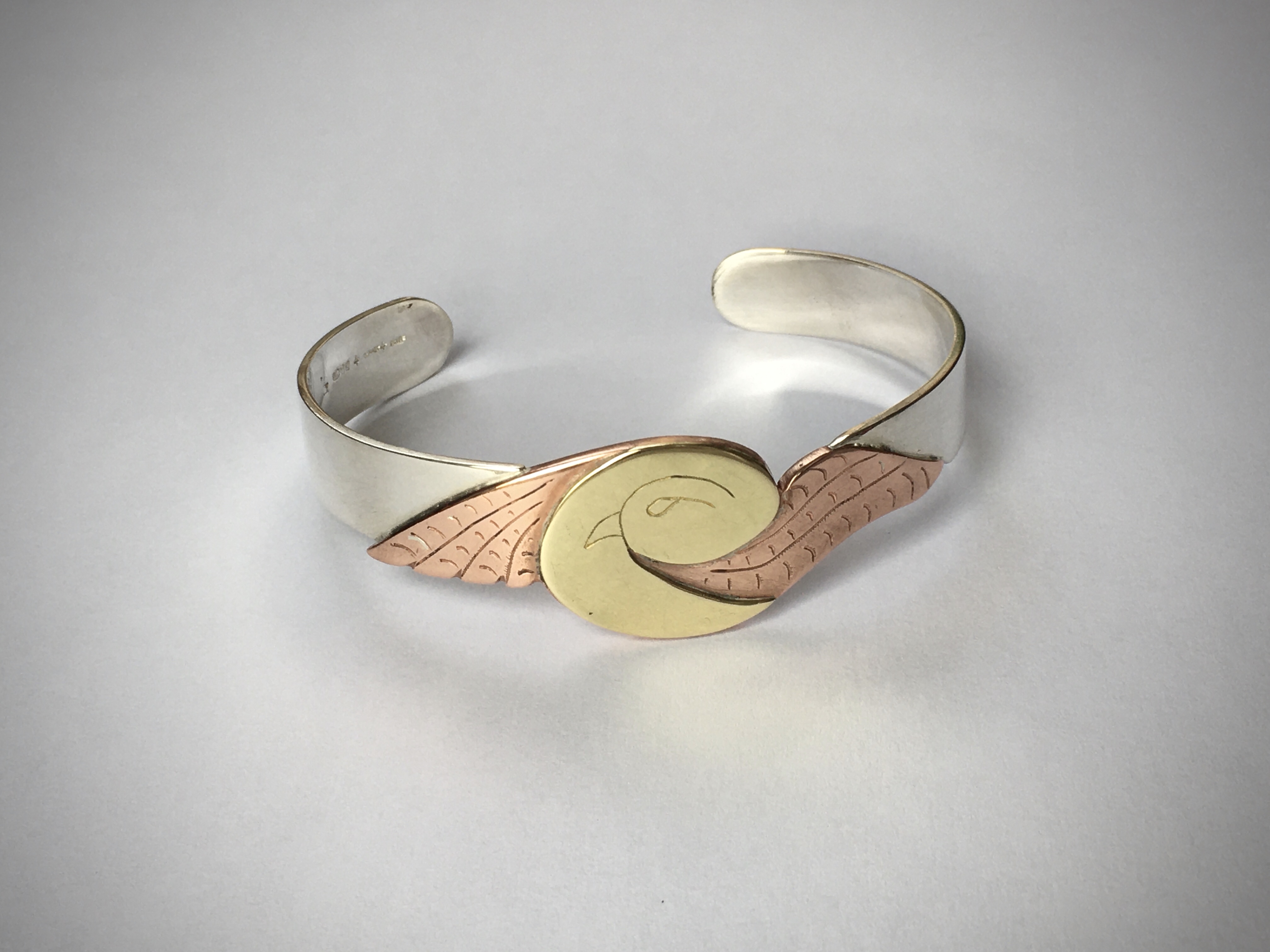 Chunky silver bird bangle with copper and brass